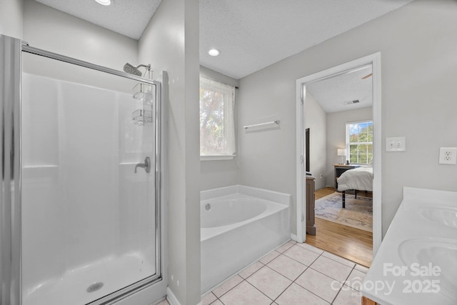 8009 Trotter Rd, Charlotte, NC 28216 - full bath featuring a shower stall, a bath, vanity, tile patterned flooring, and ensuite bath