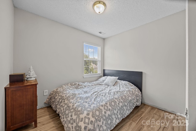 8009 Trotter Rd, Charlotte, NC 28216 - bedroom with wood finished floors and a textured ceiling
