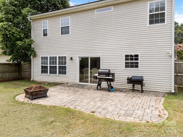 8009 Trotter Rd, Charlotte, NC 28216 - back of house with an outdoor fire pit, a fenced backyard, and a patio area