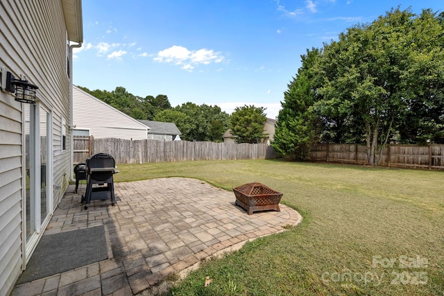 8009 Trotter Rd, Charlotte, NC 28216 - fenced backyard with area for grilling, an outdoor fire pit, and a patio area