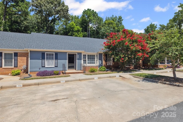 248 Pointe Cir, Rock Hill, SC 29732 - view of front facade featuring brick siding, uncovered parking, and roof with shingles