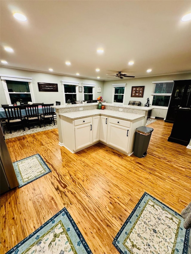 27 Walker Cove Rd, Black Mountain, NC 28711 - kitchen with light wood finished floors, open floor plan, white cabinetry, light countertops, and ceiling fan
