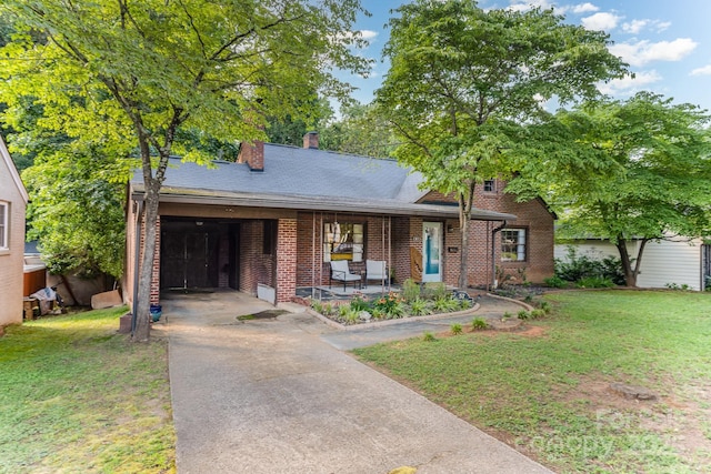 57 Patton Ct SE, Concord, NC 28025 - view of front of house featuring brick siding, a front yard, driveway, and a chimney