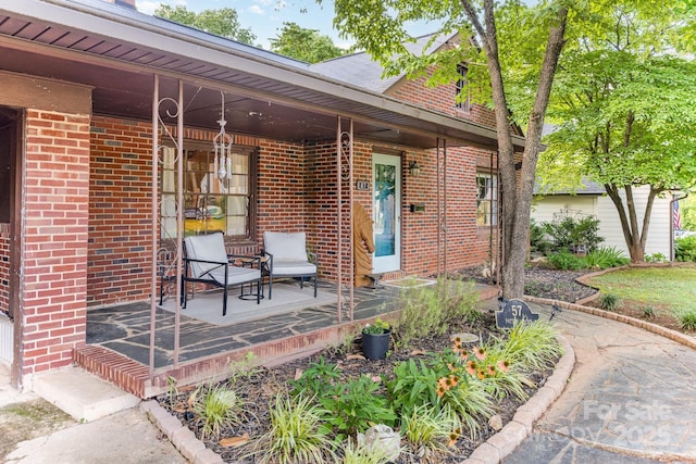 57 Patton Ct SE, Concord, NC 28025 - view of exterior entry with brick siding and a porch