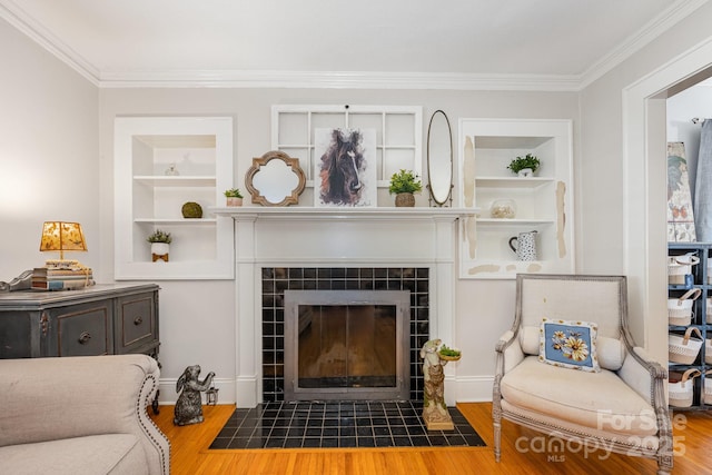 57 Patton Ct SE, Concord, NC 28025 - living area with a fireplace, wood finished floors, built in shelves, and ornamental molding