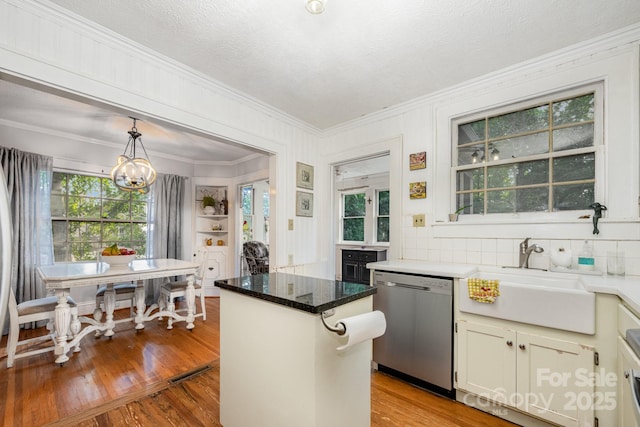 57 Patton Ct SE, Concord, NC 28025 - kitchen with stainless steel dishwasher, crown molding, wood finished floors, a chandelier, and a kitchen island