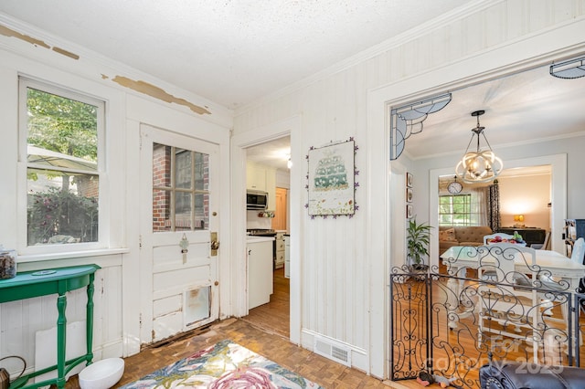 57 Patton Ct SE, Concord, NC 28025 - foyer entrance featuring crown molding, healthy amount of natural light, and a chandelier