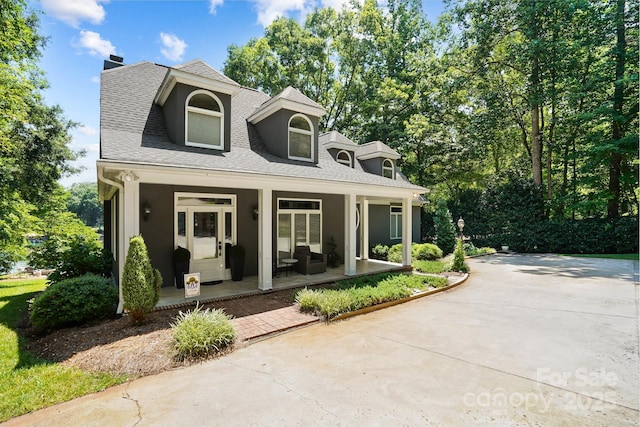 7040 Hyde St, Sherrills Ford, NC 28673 - view of front of house featuring a chimney, a porch, a shingled roof, and stucco siding