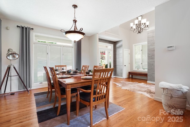 7040 Hyde St, Sherrills Ford, NC 28673 - dining area with healthy amount of natural light, light wood-style floors, and a chandelier