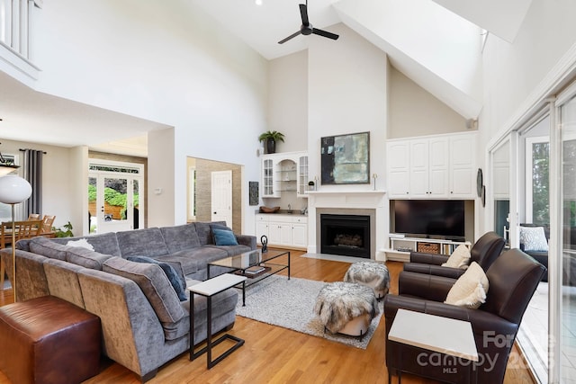 7040 Hyde St, Sherrills Ford, NC 28673 - living area with high vaulted ceiling, a ceiling fan, light wood-style floors, and a fireplace with flush hearth