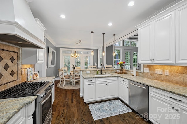 835 Misty Arbor Frd Unit 76, Clover, SC 29710 - kitchen featuring appliances with stainless steel finishes, custom range hood, a peninsula, a chandelier, and tasteful backsplash