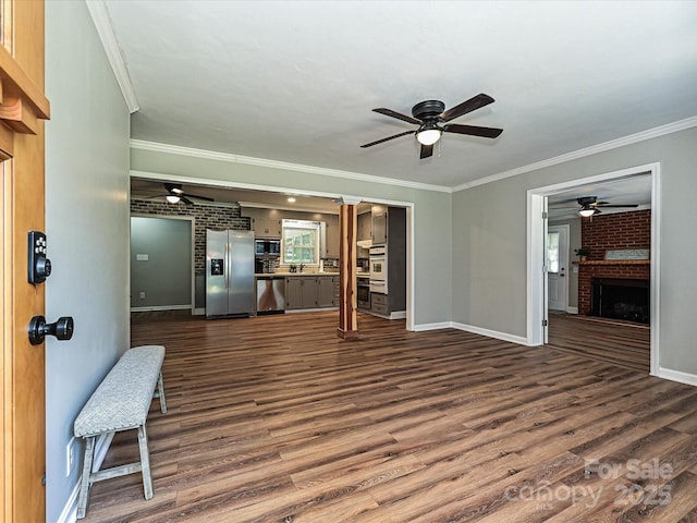 159 Valleydale Dr, Gastonia, NC 28056 - unfurnished living room with ceiling fan, ornamental molding, dark wood finished floors, and a fireplace