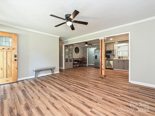 159 Valleydale Dr, Gastonia, NC 28056 - unfurnished living room featuring ceiling fan, crown molding, wood finished floors, and decorative columns