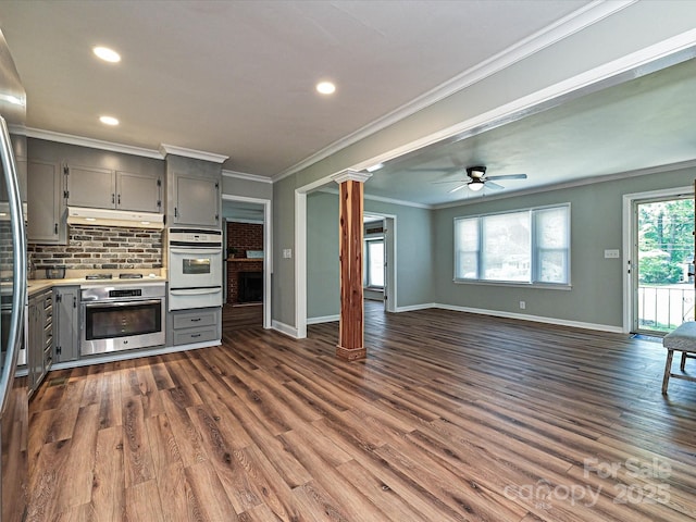 159 Valleydale Dr, Gastonia, NC 28056 - unfurnished living room with dark wood-style flooring, recessed lighting, ornamental molding, ceiling fan, and decorative columns
