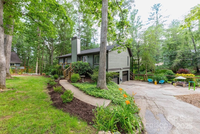 14 New Bern Dr, Fletcher, NC 28732 - view of front of home featuring a chimney, an attached garage, driveway, stairway, and a front yard