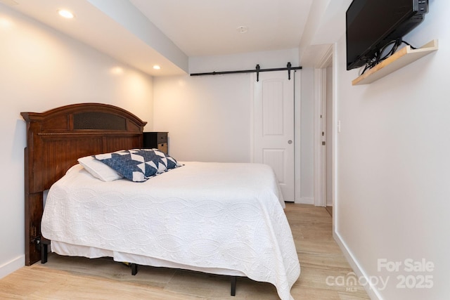 14 New Bern Dr, Fletcher, NC 28732 - bedroom with light wood-type flooring, recessed lighting, and a barn door