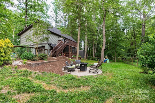 14 New Bern Dr, Fletcher, NC 28732 - rear view of house featuring stairway, a fire pit, a deck, a patio, and a playground
