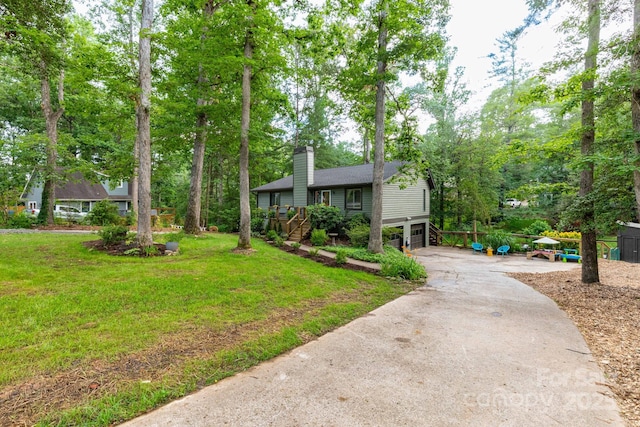 14 New Bern Dr, Fletcher, NC 28732 - view of front of property with driveway, a garage, a chimney, a front lawn, and view of scattered trees
