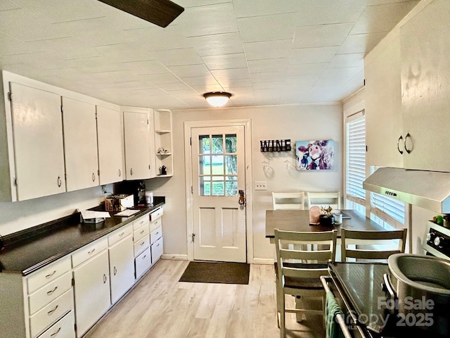 39 Hemphill Rd, Waynesville, NC 28785 - kitchen with dark countertops, light wood-type flooring, white cabinetry, and open shelves