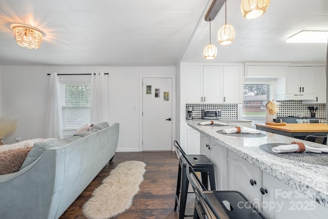 700 Perkins St, Lowell, NC 28098 - kitchen with decorative backsplash, white cabinets, decorative light fixtures, and dark wood-style floors