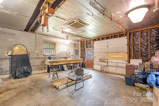 700 Perkins St, Lowell, NC 28098 - garage featuring concrete block wall and a heating unit