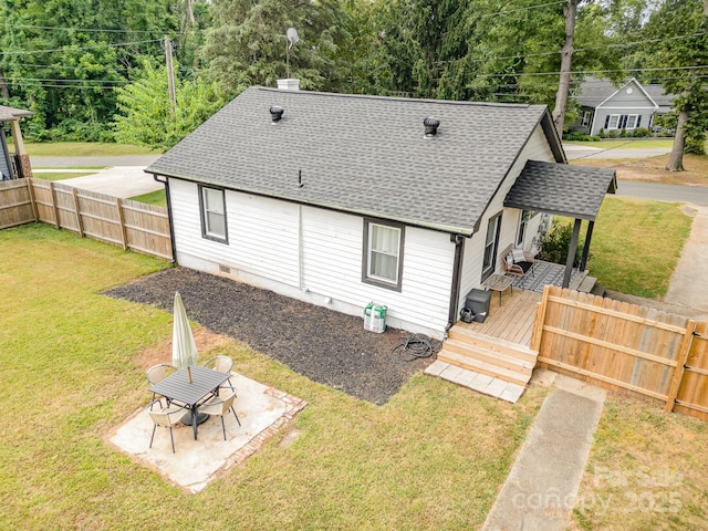 700 Perkins St, Lowell, NC 28098 - rear view of property featuring roof with shingles, a wooden deck, and a patio