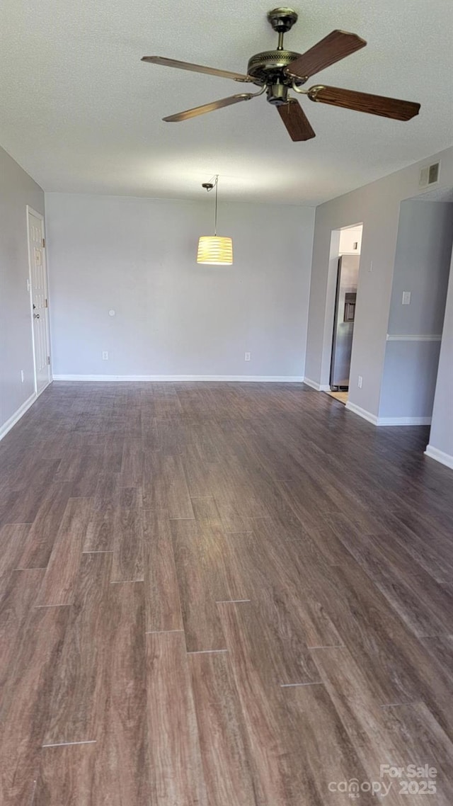 2116 S Main St, Kannapolis, NC 28081 - unfurnished living room featuring ceiling fan, dark wood finished floors, and a textured ceiling