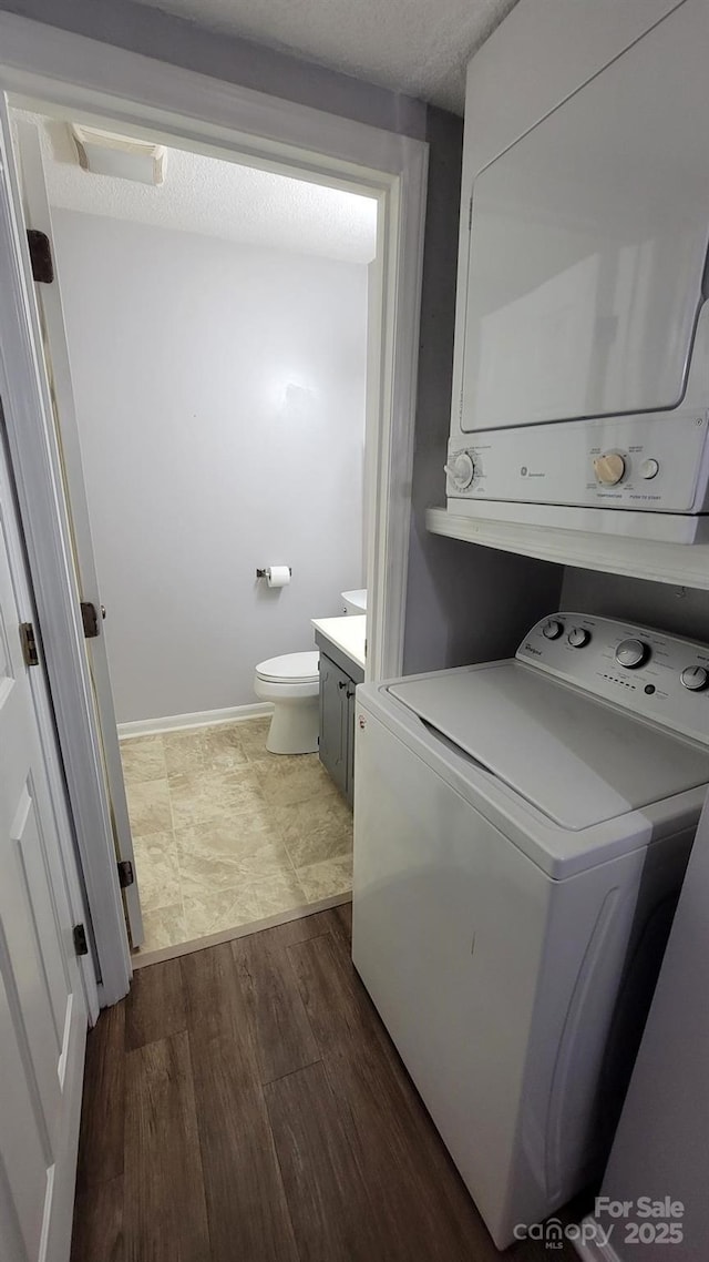 2116 S Main St, Kannapolis, NC 28081 - laundry area with stacked washer / dryer and dark wood-style floors