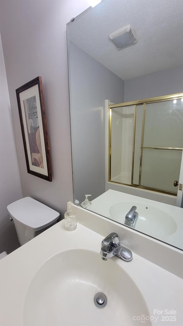 2116 S Main St, Kannapolis, NC 28081 - bathroom with vanity, a textured ceiling, and a shower with shower door
