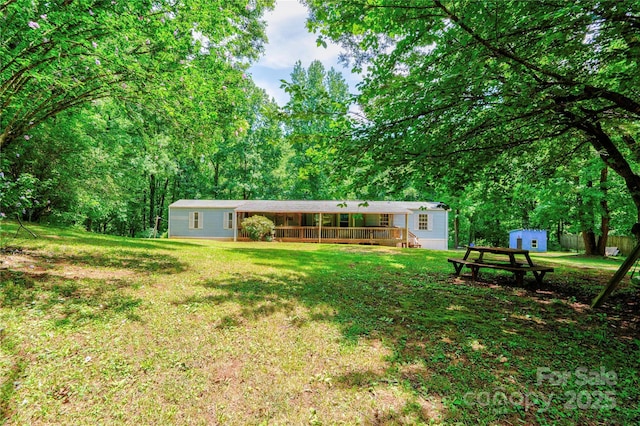 121 Whipporwill Ct, Grover, NC 28073 - view of green lawn featuring a storage unit and a wooden deck