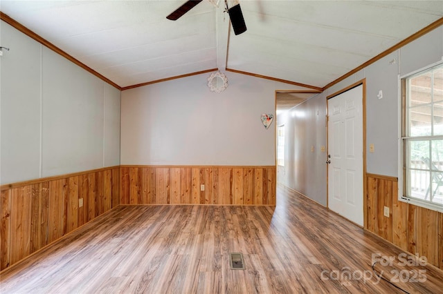 121 Whipporwill Ct, Grover, NC 28073 - spare room featuring wood finished floors, wood walls, a wainscoted wall, a ceiling fan, and crown molding