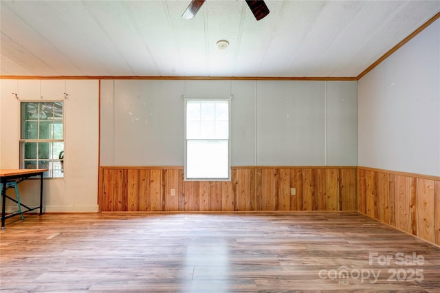 121 Whipporwill Ct, Grover, NC 28073 - spare room featuring wooden walls, wood finished floors, ceiling fan, wainscoting, and ornamental molding