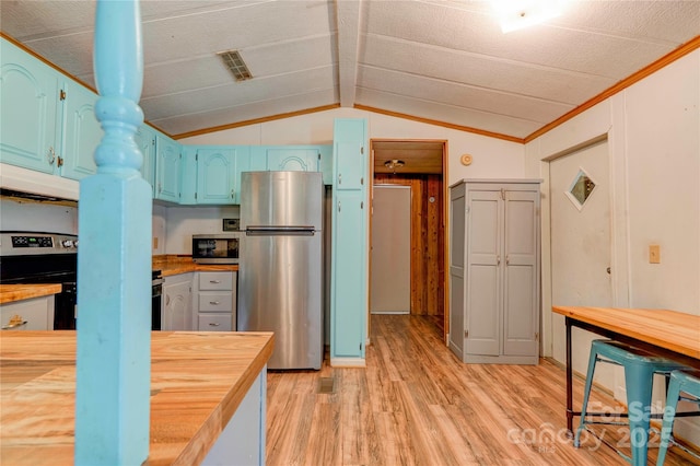 121 Whipporwill Ct, Grover, NC 28073 - kitchen with butcher block counters, stainless steel appliances, light wood-style floors, extractor fan, and blue cabinetry