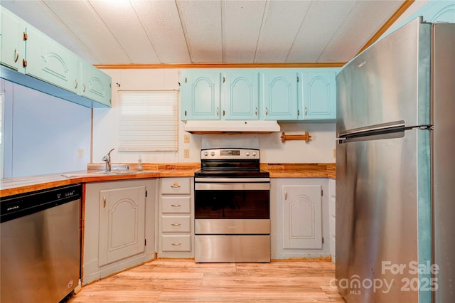 121 Whipporwill Ct, Grover, NC 28073 - kitchen with appliances with stainless steel finishes, under cabinet range hood, light wood-style floors, blue cabinetry, and light countertops