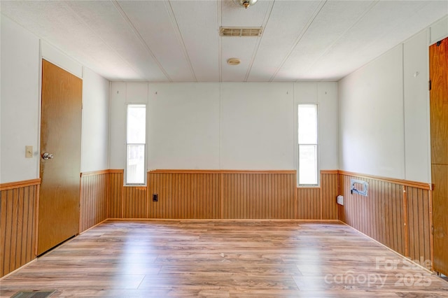 121 Whipporwill Ct, Grover, NC 28073 - empty room with wood finished floors, wainscoting, and wood walls