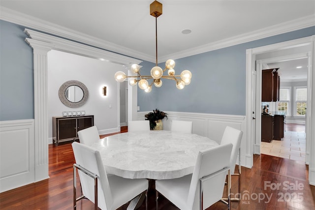 4552 Sawgrass Ct, Denver, NC 28037 - dining space with ornamental molding, dark wood-style floors, a chandelier, a wainscoted wall, and a decorative wall