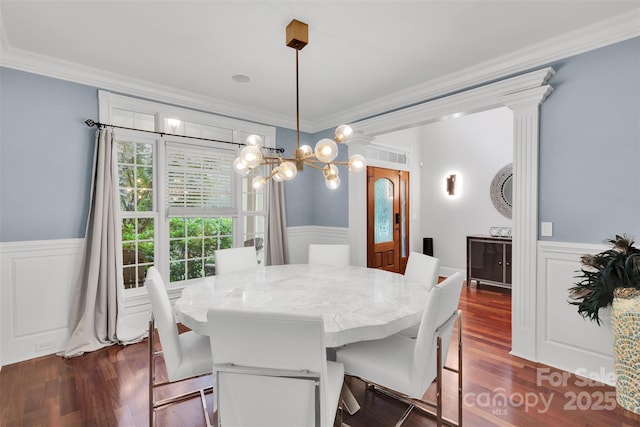 4552 Sawgrass Ct, Denver, NC 28037 - dining room featuring a wainscoted wall, ornamental molding, dark wood-style flooring, and a chandelier