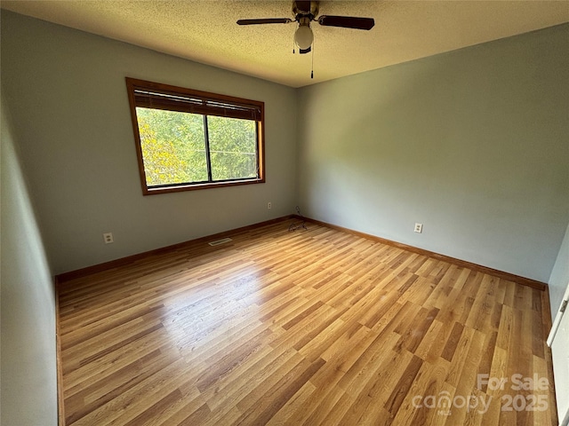 39 Moondust Dr, Waynesville, NC 28786 - spare room featuring wood finished floors, a ceiling fan, and a textured ceiling