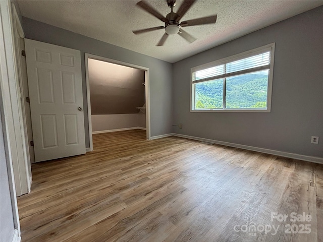 39 Moondust Dr, Waynesville, NC 28786 - empty room featuring wood finished floors, ceiling fan, and a textured ceiling