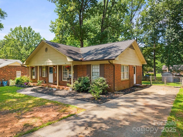 10108 Starwood Dr Unit 13, Charlotte, NC 28215 - view of front of house with covered porch, brick siding, driveway, and roof with shingles