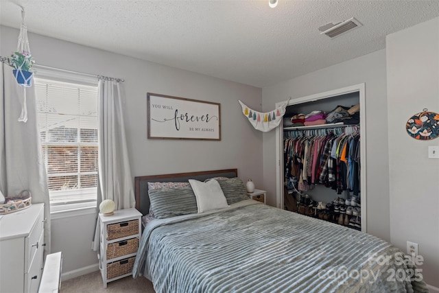 10108 Starwood Dr Unit 13, Charlotte, NC 28215 - bedroom featuring light colored carpet, a textured ceiling, and a closet
