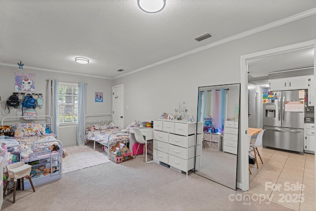 10108 Starwood Dr Unit 13, Charlotte, NC 28215 - bedroom featuring stainless steel refrigerator with ice dispenser, ornamental molding, a textured ceiling, and light colored carpet