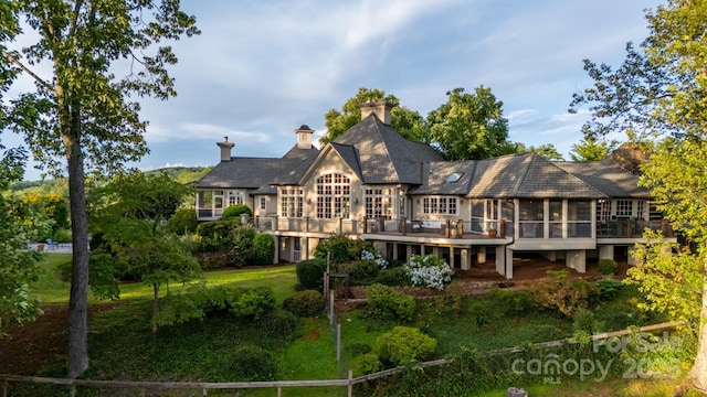 650 Golf Course Rd, Columbus, NC 28722 - back of house featuring a sunroom, a deck, and a lawn