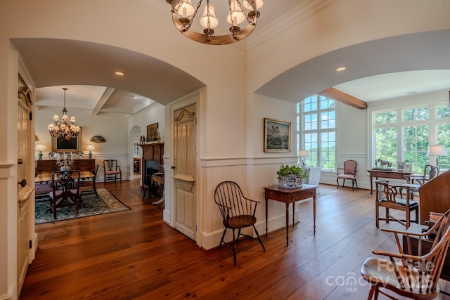 650 Golf Course Rd, Columbus, NC 28722 - sitting room with a chandelier, arched walkways, dark wood-style floors, beam ceiling, and a wainscoted wall