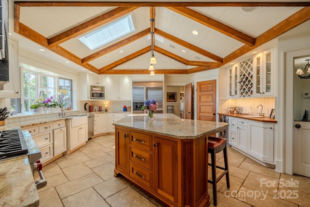 650 Golf Course Rd, Columbus, NC 28722 - kitchen with appliances with stainless steel finishes, backsplash, wine cooler, and a kitchen island