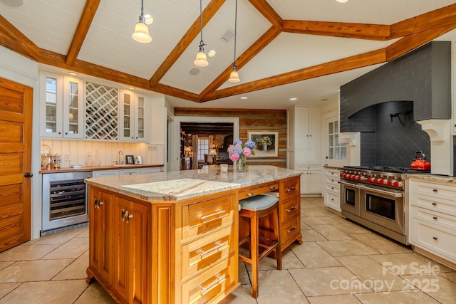 650 Golf Course Rd, Columbus, NC 28722 - kitchen featuring beverage cooler, double oven range, light tile patterned flooring, glass insert cabinets, and a large island