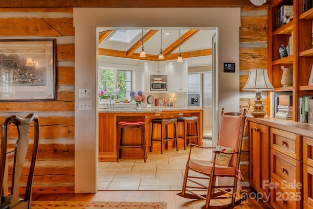 650 Golf Course Rd, Columbus, NC 28722 - kitchen with stainless steel microwave, beamed ceiling, built in refrigerator, a skylight, and white cabinets