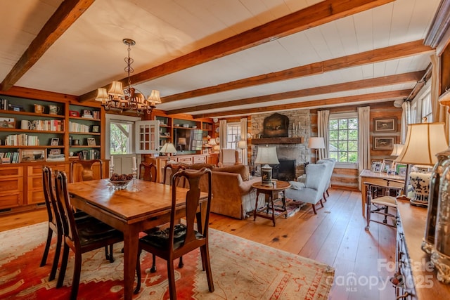 650 Golf Course Rd, Columbus, NC 28722 - dining area with a chandelier, light wood finished floors, beam ceiling, and a fireplace