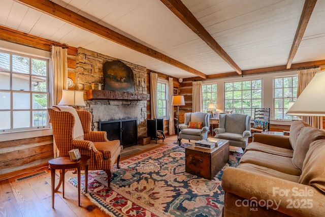 650 Golf Course Rd, Columbus, NC 28722 - living room with hardwood / wood-style floors, beamed ceiling, a fireplace, healthy amount of natural light, and rustic walls