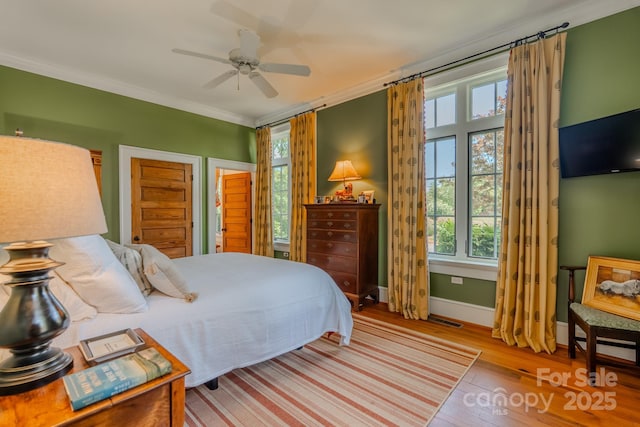 650 Golf Course Rd, Columbus, NC 28722 - bedroom featuring multiple windows, wood finished floors, ornamental molding, and ceiling fan